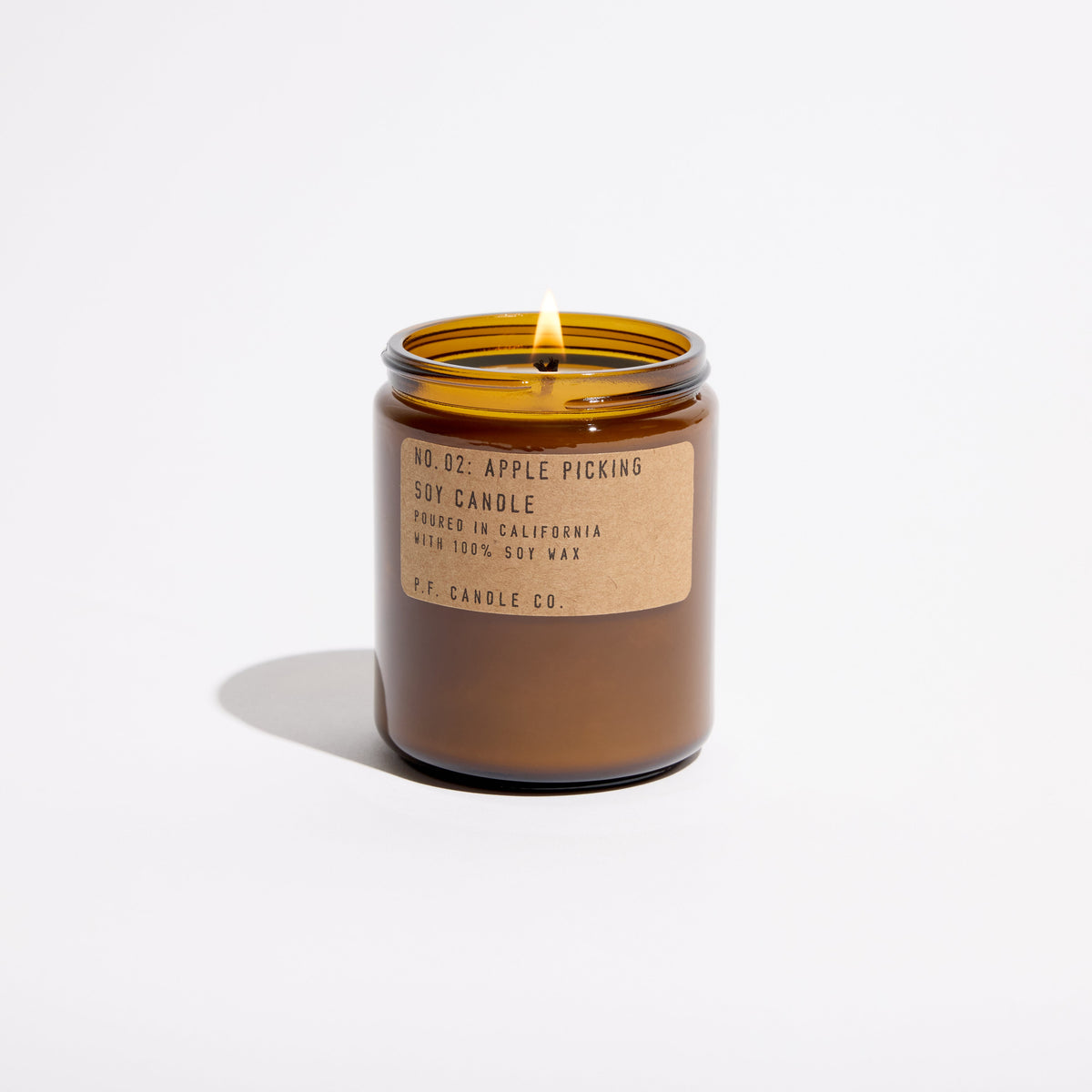 P.F. Candle Co. Standard Candle in Apple Picking, 7.2 oz amber glass jar with brass lid