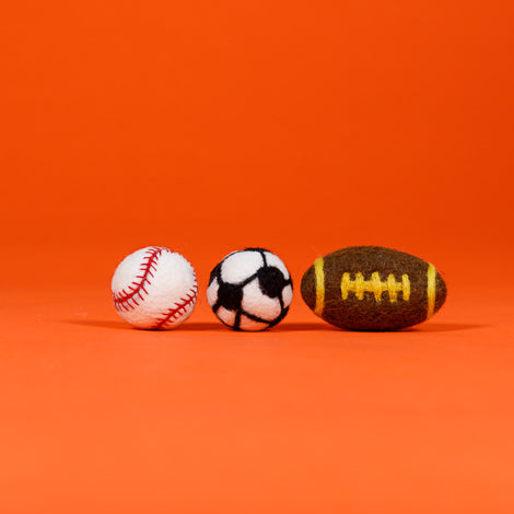 Ware of the Dog set of 3 felted wool sports ball cat toys — baseball, soccer ball, and football on orange background