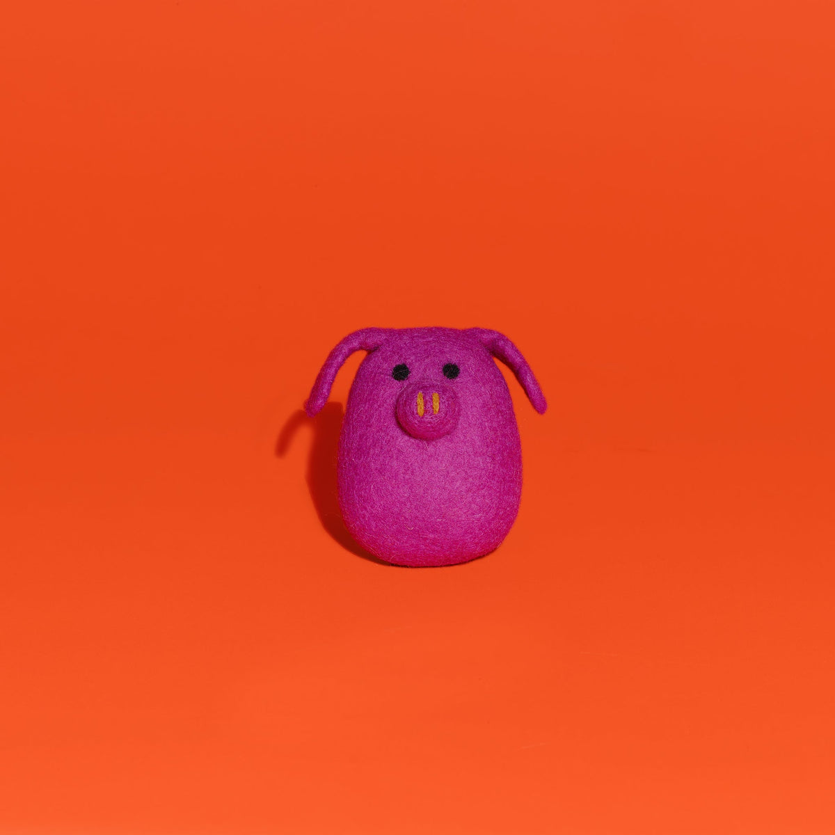 Ware of the Dog felted wool pink pig dog toy on orange background