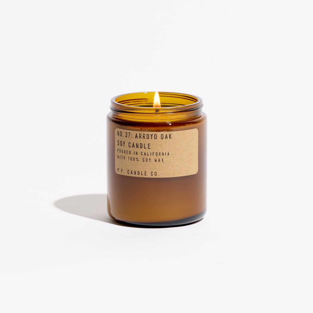 P.F. Candle Co. Standard Candle in Arroyo Oak, 7.2 oz amber glass jar with brass lid