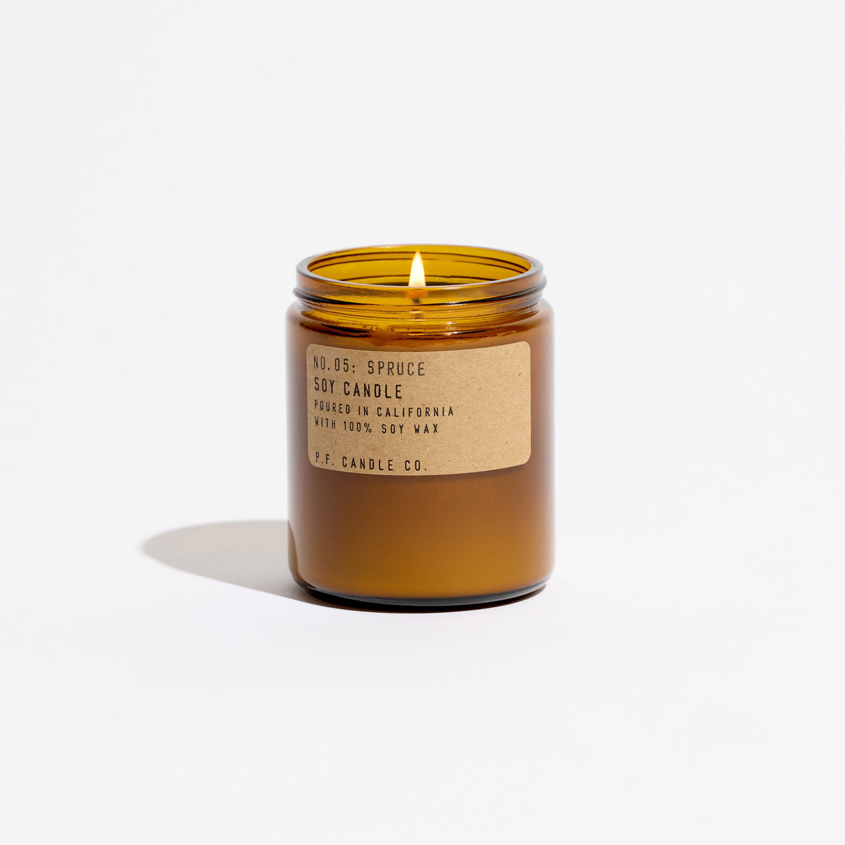 P.F. Candle Co. Standard Candle in Spruce, 7.2 oz amber glass jar with brass lid