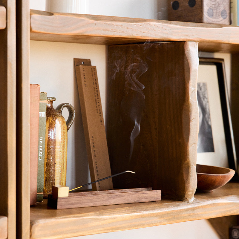 P.F. Candle Co. Incense Sticks in Teakwood & Tobacco burning on a wood shelf