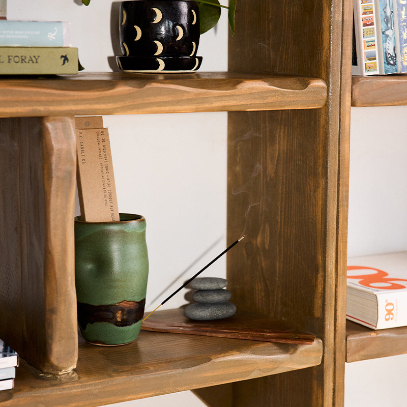 P.F. Candle Co. Incense Sticks in Wild Herb Tonic burning on a wood shelf
