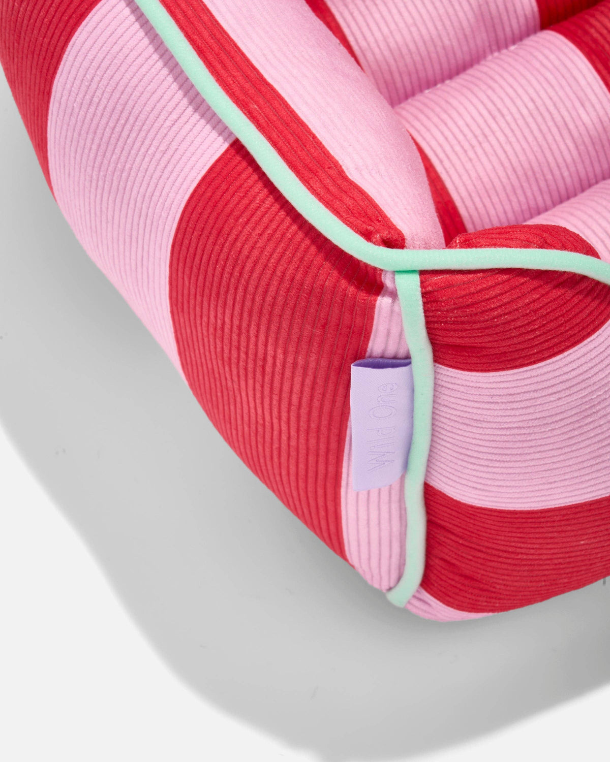 Close-up of the Wild One Cat Bolster Bed corduroy bolster in Bubblegum