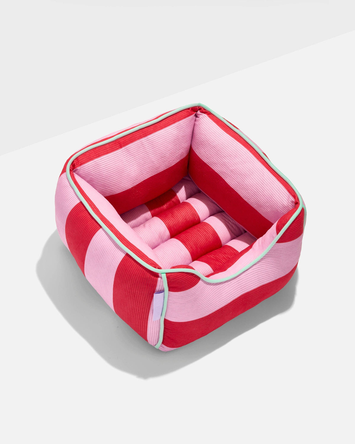 Wild One Cat Bolster Bed in Bubblegum pink and red striped corduroy