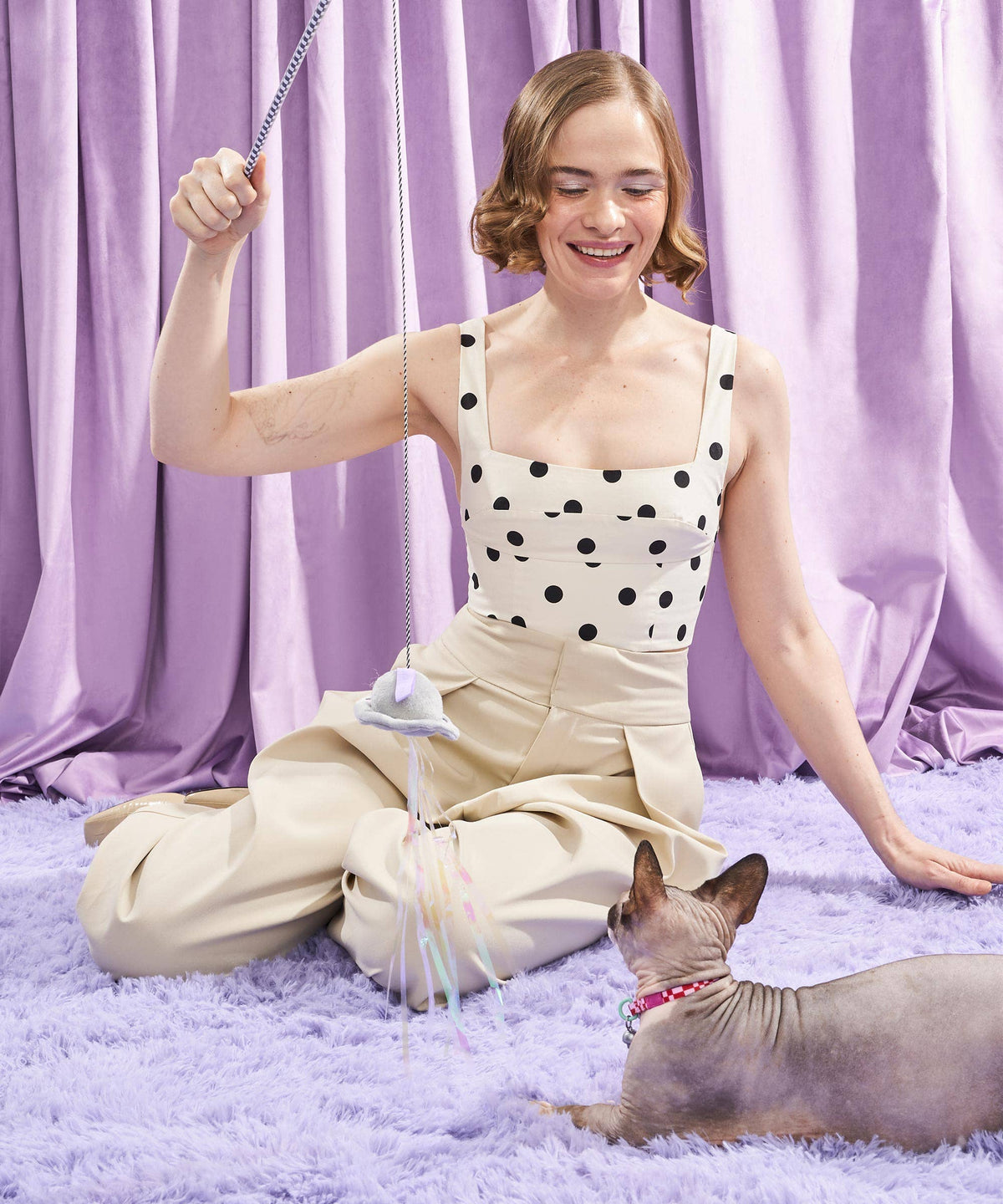 Woman playing with a cat using the Wild One Cat Wild Wand