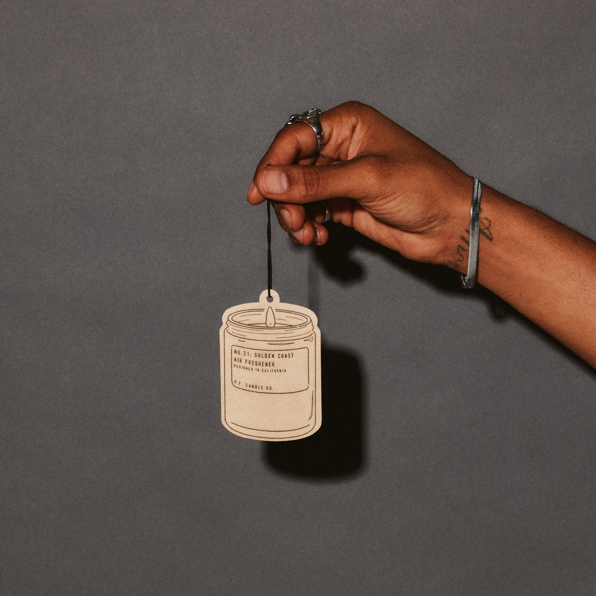 P.F. Candle Co. Air Freshener 2-Pack in Golden Coast, air freshener held by its elastic string