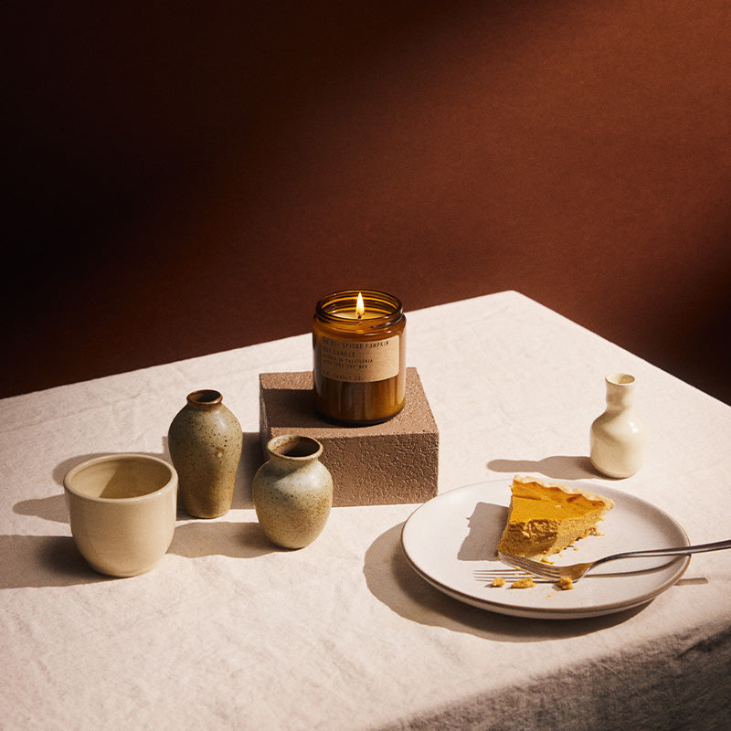 P.F. Candle Co. Standard Candle in Spiced Pumpkin styled with ceramics and a slice of pie